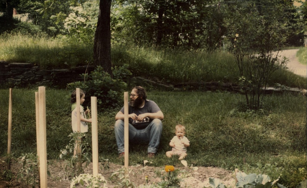 Baby Emily in the garden with her sister and dad circa 1978